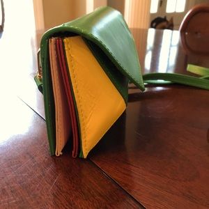 Italian leather Green cross-body. Red, yellow and pink accordion style sides.